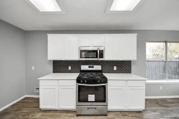 a kitchen with a stove and a microwave