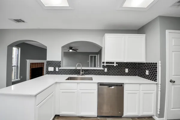 a kitchen with a sink and cabinets