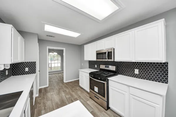 a kitchen with a stove and a microwave