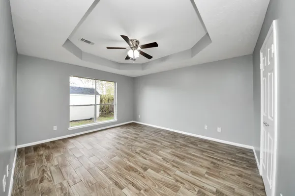 wooden floor in an empty room with a window