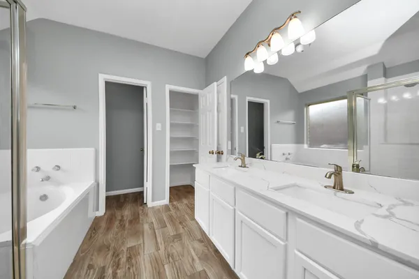 a bathroom with a double vanity sink and mirror with shower