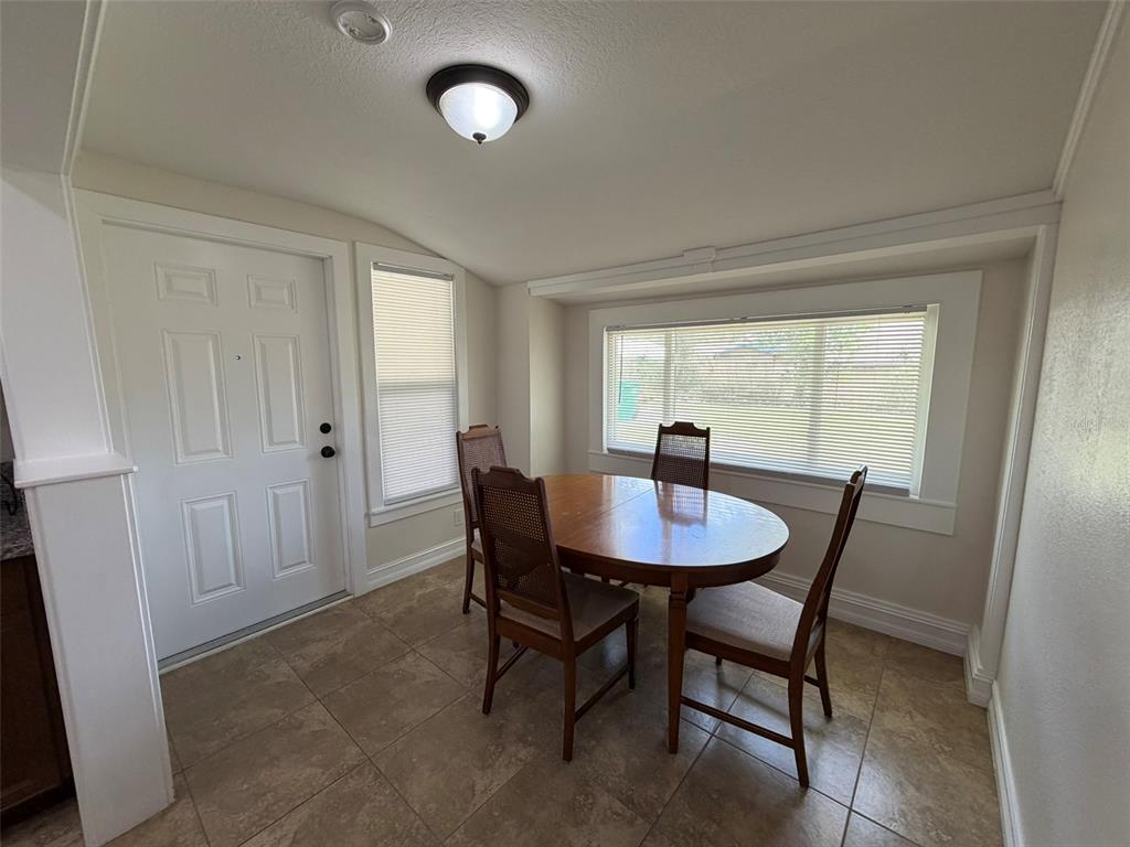 903 East New York Avenue Deland, FL 32724 - Photo 13 of 29 a view of a dining room with furniture and window