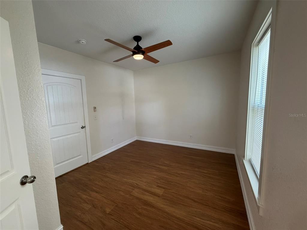 903 East New York Avenue Deland, FL 32724 - Photo 14 of 29 wooden floor in an empty room
