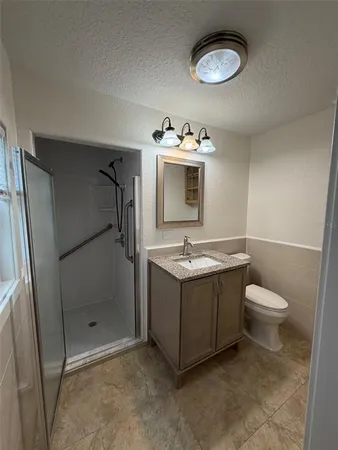 a bathroom with a sink toilet and shower