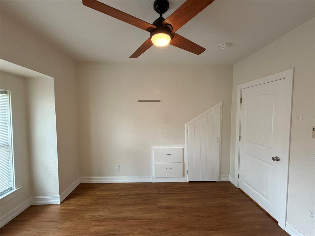 903 East New York Avenue Deland, FL 32724 - Photo 21 of 29 an empty room with fan and windows
