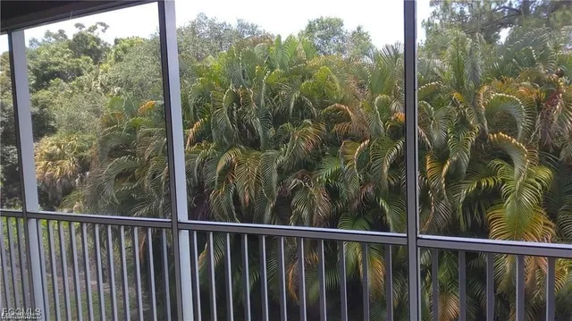 a view of a balcony with a yard
