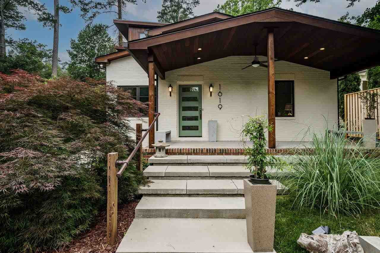 1619 Lorraine Road Raleigh, NC 27607 - Photo 2 of 30 The Brazilian Teak Porch Ceiling (rot and insect resistant) offers a Zenlike welcome for your guests. The convenient guest parking are is just steps away from the lovely covered porch. The custom concrete benches and planters convey with the property. Front Porch