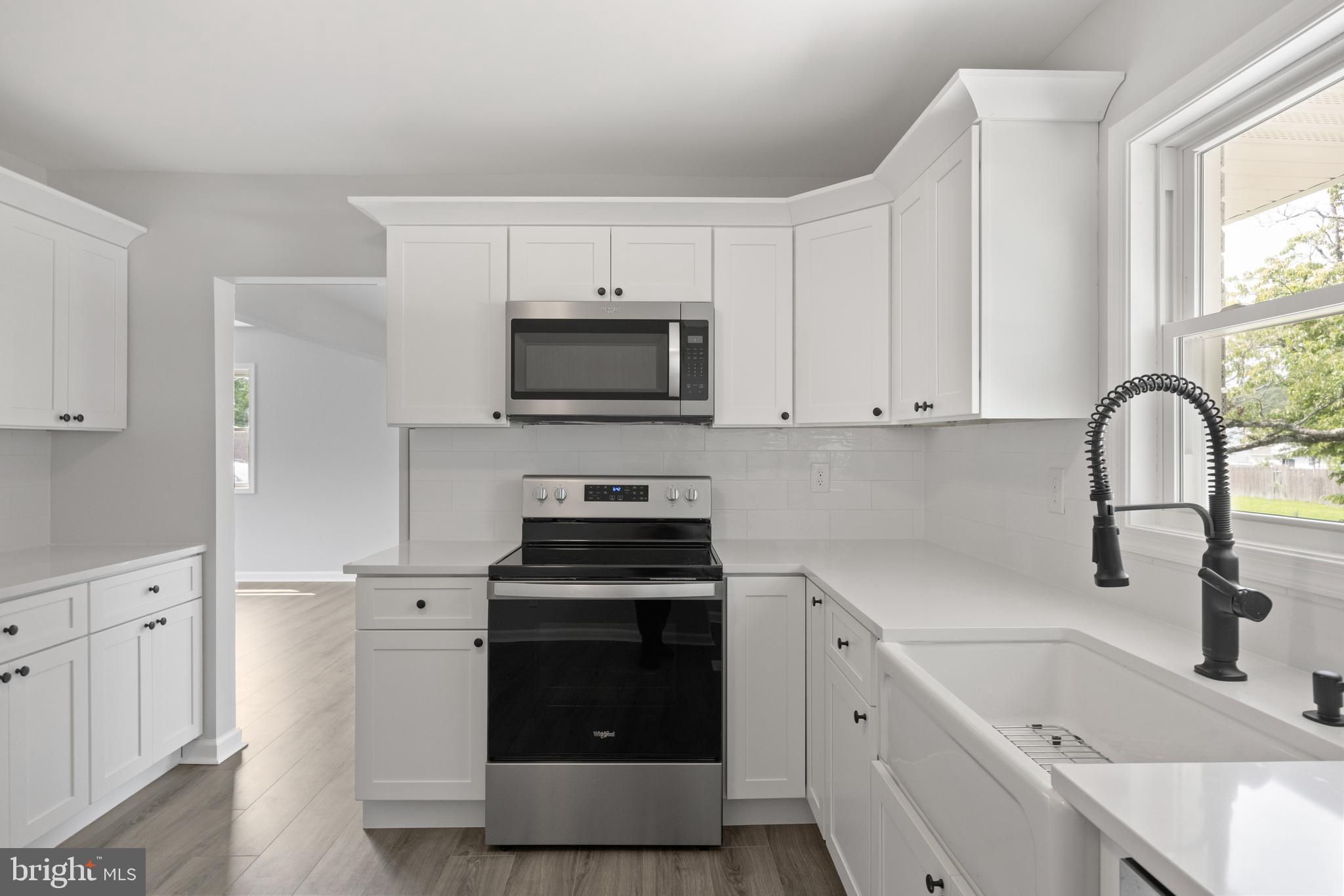 100 North Burlington Road Bridgeton, NJ 08302 - Photo 10 of 18 a kitchen with a sink stove and cabinets