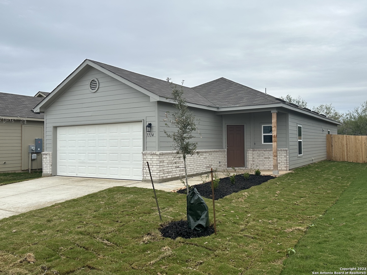 a backyard of a house with table and chairs