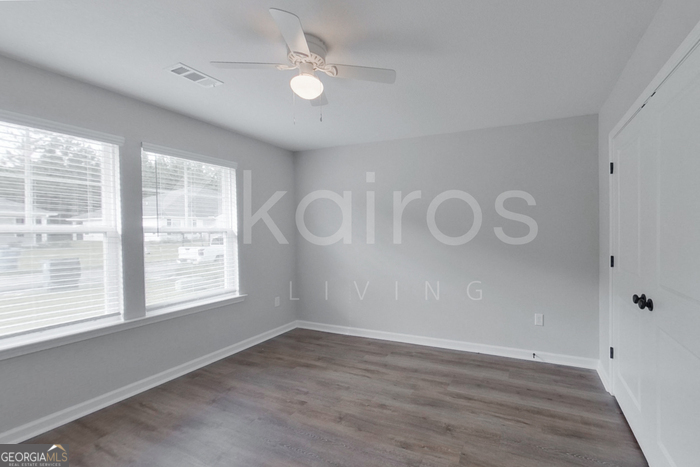122 Cottage Grove Road Brunswick, GA 31525 - Photo 11 of 20 a view of an empty room with a window and wooden floor