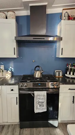 a stove top oven sitting inside of a kitchen