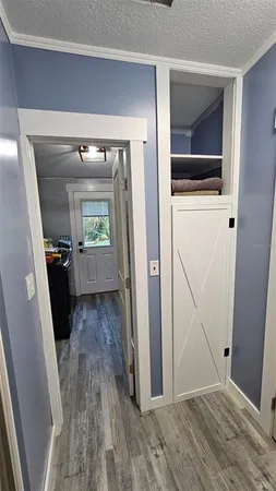 a view of hallway with wooden floor