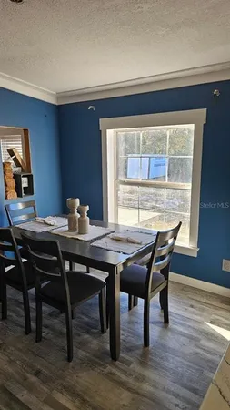 a view of a dining room with furniture window and wooden floor