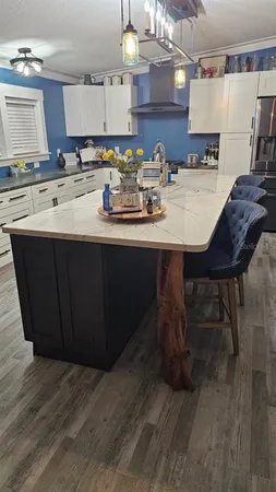 a kitchen with a sink cabinets and wooden floor