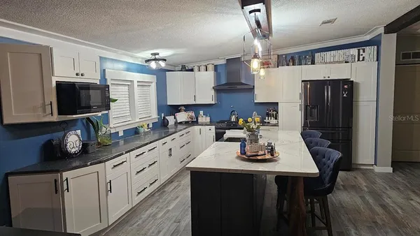 a kitchen with stainless steel appliances a sink stove and refrigerator