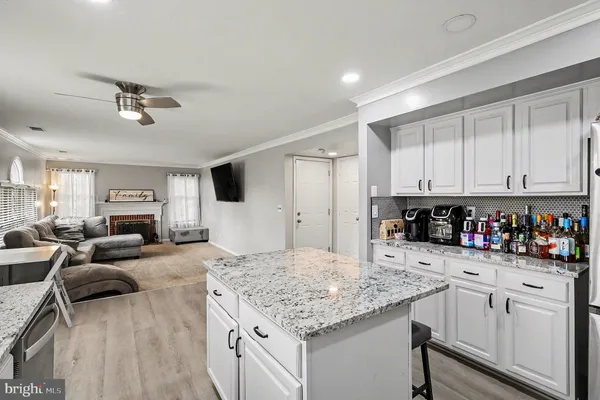 a kitchen with white cabinets and sink