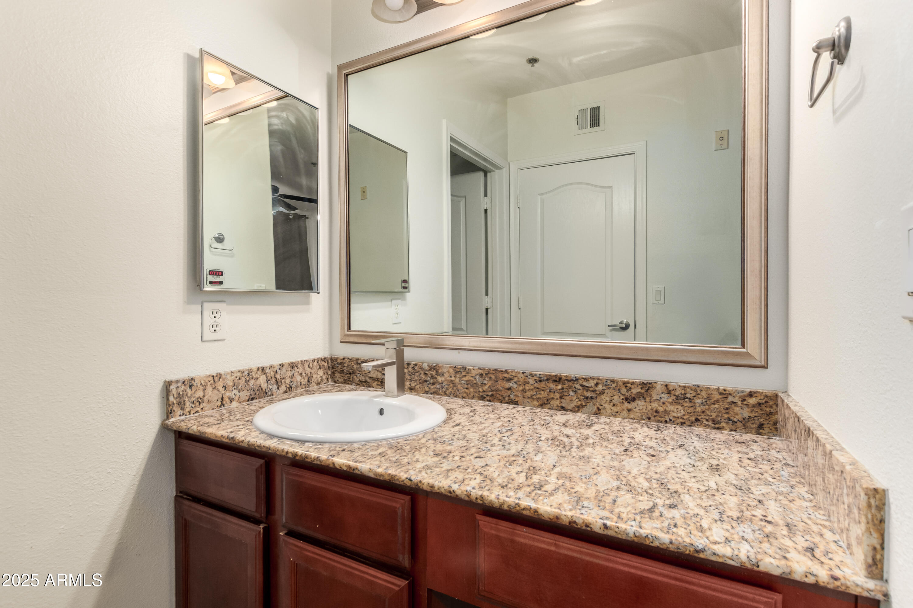2134 East Broadway Road, Unit 2054 Tempe, AZ 85282 - Photo 15 of 17 a bathroom with a sink and a mirror