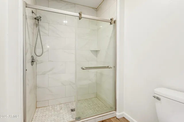 a bathroom with a glass door shower