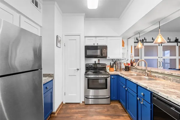a kitchen with stainless steel appliances granite countertop a refrigerator stove and sink
