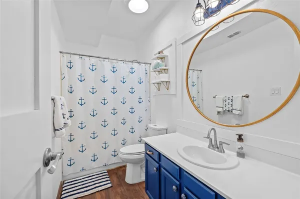 a bathroom with a sink a toilet and a mirror