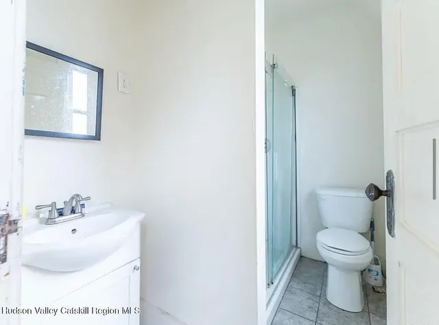 a bathroom with a sink toilet and a mirror