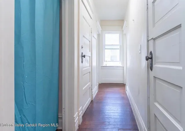a view of a room with furniture and wooden floor