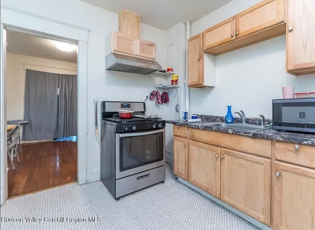 a view of staircase with white walls and white door