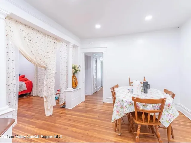 a dining room with furniture and wooden floor