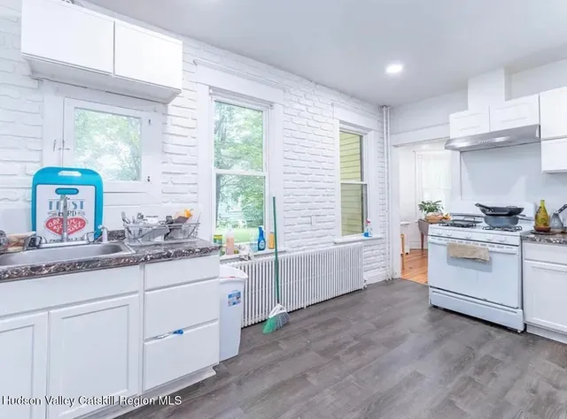 a kitchen with white cabinets and white appliances