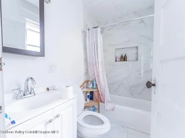 a bathroom with a sink a toilet and a bathtub