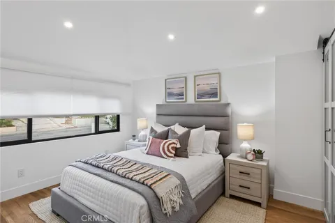 a bedroom with a bed and a painting on the wall