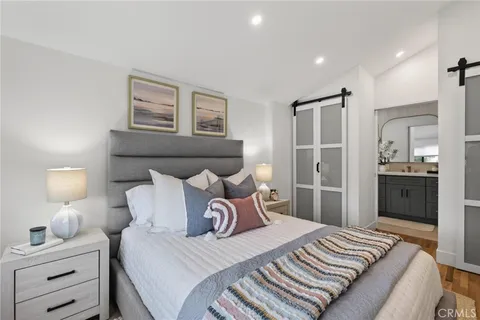 a bedroom with a bed and a lamp