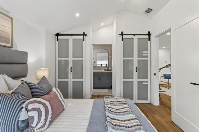 a bedroom with a bed and a view of bathroom