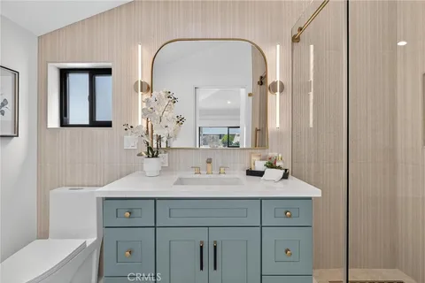 a bathroom with a double vanity sink and a mirror