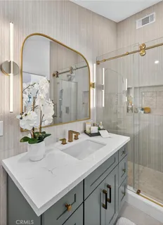 a bathroom with a sink a mirror and a shower