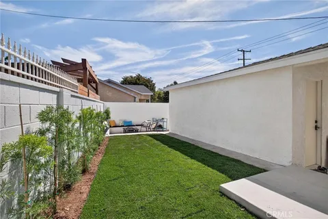 a view of a backyard with plants and a patio