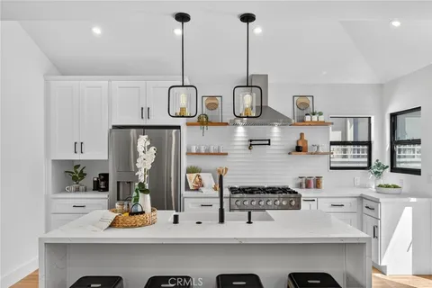 a kitchen with a sink a stove and cabinets