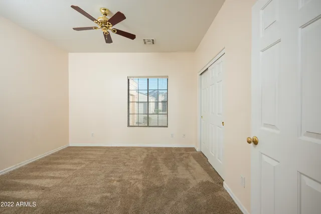 a view of room with hardwood floor and ceiling fan