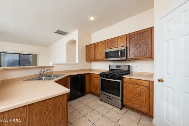 a kitchen with a sink stove and microwave