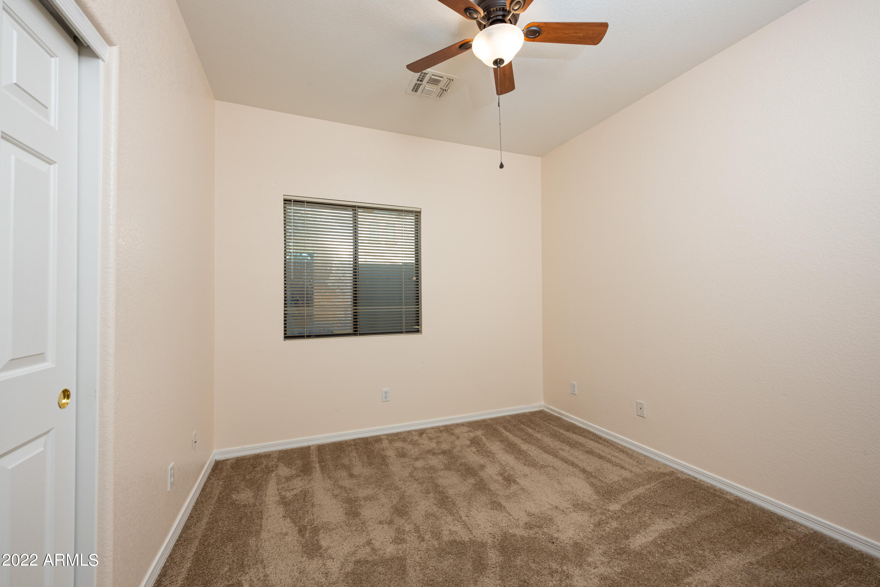 7030 South 30th Street Phoenix, AZ 85042 - Photo 9 of 18 an empty room with a chandelier fan