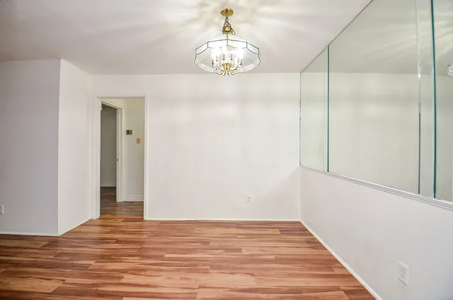a view of a hallway view with wooden floor and staircase