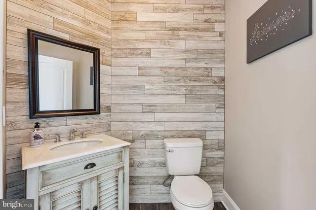 a bathroom with a sink mirror vanity and toilet
