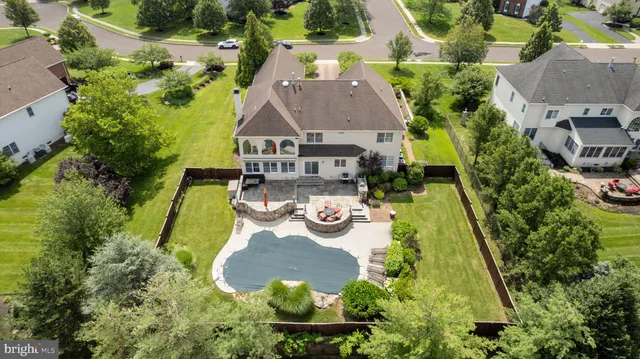an aerial view of a house with yard swimming pool and outdoor seating