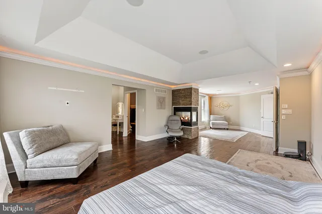 a bedroom with furniture and wooden floor