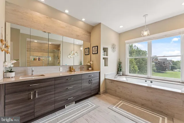 a bathroom with a sink mirror and a bathtub