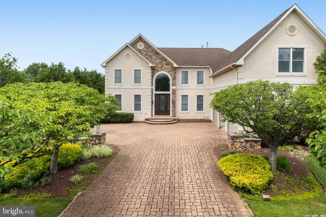 a front view of a house with a yard and potted plants