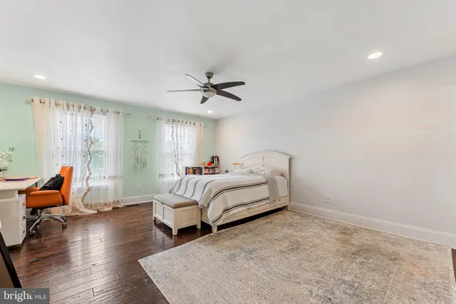 a bedroom with furniture and wooden floor