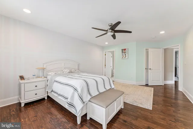 a spacious bedroom with a bed and a window