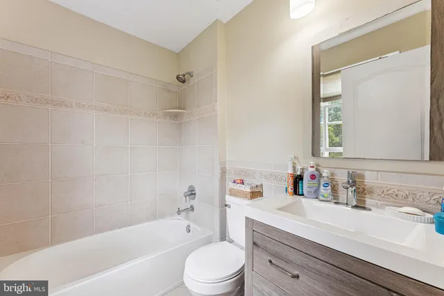 a bathroom with a sink a toilet and a bathtub