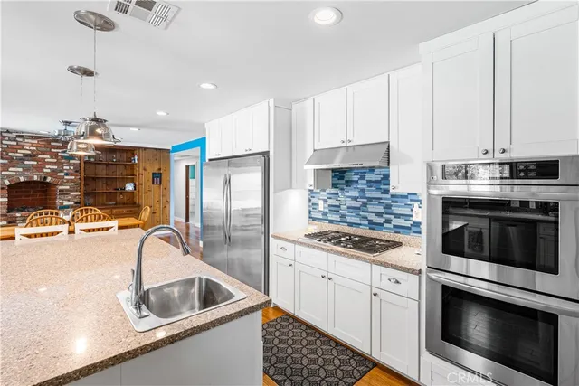 a kitchen with a sink cabinets and stainless steel appliances